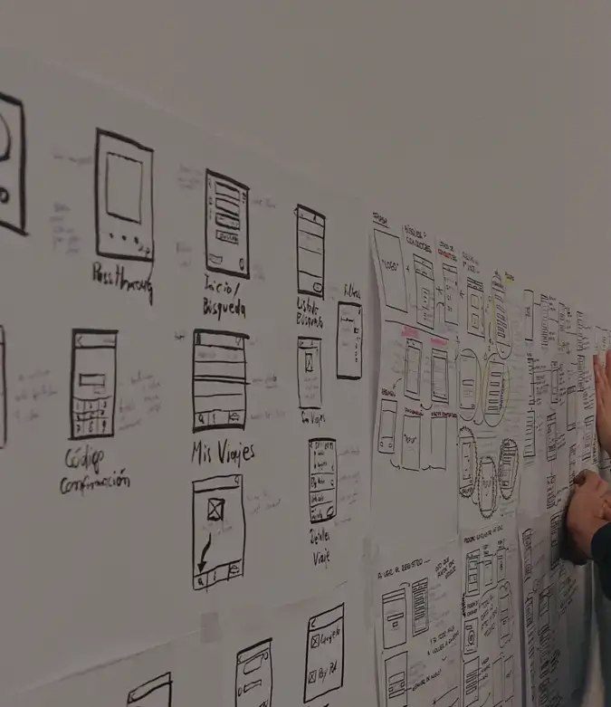Wall of papers that contain UI and UX wireframes